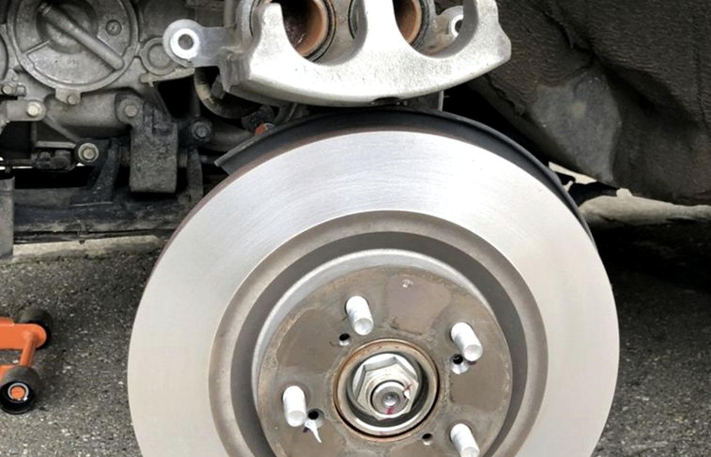 New rotor and caliper bracket during a Chattanooga brake repair