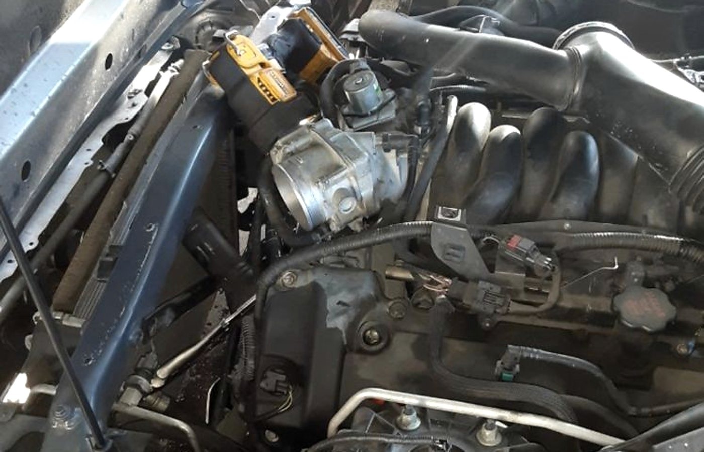 Cordless tools staged in an engine bay at a Chattanooga service call